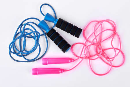 Blue and pink skipping ropes. High quality jump ropes isolated on white background. Gym equipment on sale.の写真素材