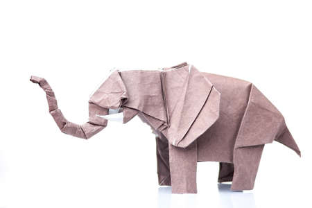 Brown elephant origami figurine. Paper design of animals. Difficult and beautiful art made by child.の写真素材
