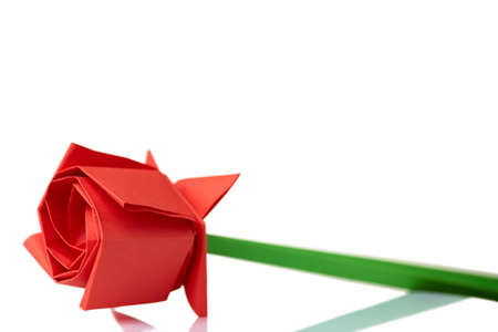 Red rose origami model. Paper folding, hand crafting project. Childs gift for mother.の写真素材