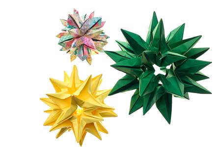 Three spiky origami decorations on white. Stars and cosmic bodies. Advanced level of paper folding art.の写真素材