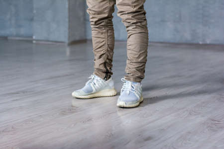 Legs of hip-hop dancer. Stylish hip-hop dancer on grey background, cropped image.の写真素材