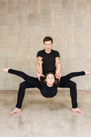 Couple of sporty ballet in art performance. Modern dance couple performing element of contemporary dance on studio background.の写真素材