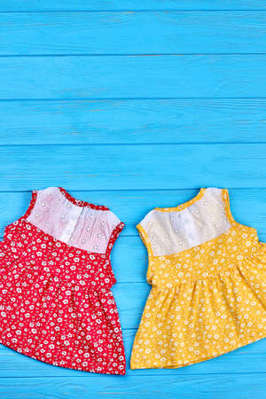 Top view of beautiful baby vintage dresses. Summer cute baby girls sundresses and copy space. Little girls summer fashion retro style.の写真素材