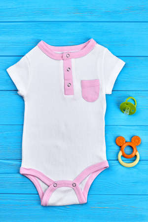 One-piece baby cotton bodysuit. Newborn cotton organic bodysuit and toy accessories, blue wooden...