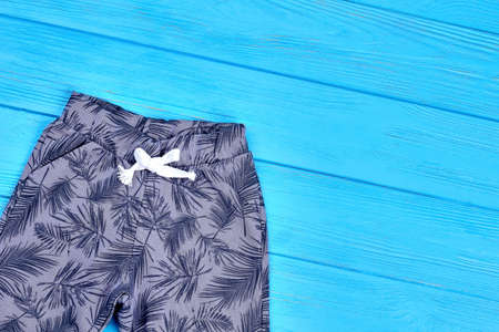 Little girl fashion printed pants. Top view of trendy cotton leggings for kids, copy space. Children cotton new clothing.の写真素材