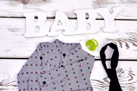 Baby boy modern boutique clothes. Toddler boy cute grey dotted shirt, black tie, pacifier, word...