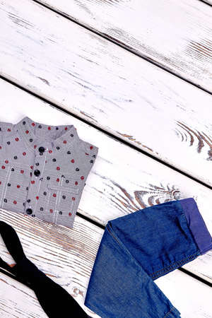 Baby boy new trendy clothes. Toddler boy spring or autumn apparel on wooden background. Childs fashion garment, copy space.の写真素材