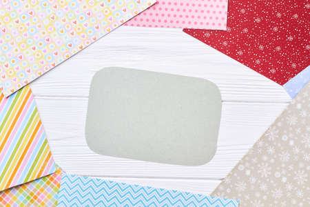 Patterned paper for New Year craft. Sheets of multicolored paper with winter design and empty sheet of paper for text, top view. New Year paper handicraft concept.の写真素材