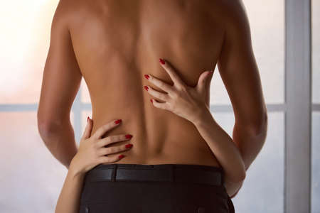 Female hands, male body. Sensual young couple, foreplay.の写真素材