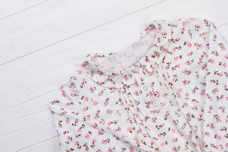 Girls blouse with flower pattern. Stylish top with collar and button-up neck. Beautiful clothing for romantic mood.の写真素材