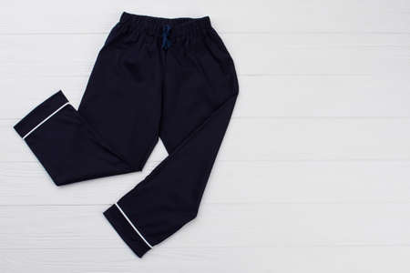 Pajama pants for teenager boy on shop display. Dark blue and white. Smooth and soft cotton, waistband with drawstring.の写真素材