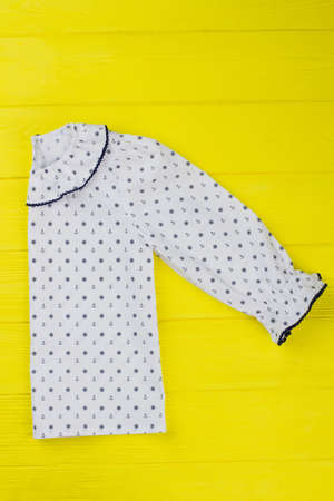 Beautiful blouse with sailor pattern. Garment decorated with edging on collar and cuffs. Girls fashion.の写真素材