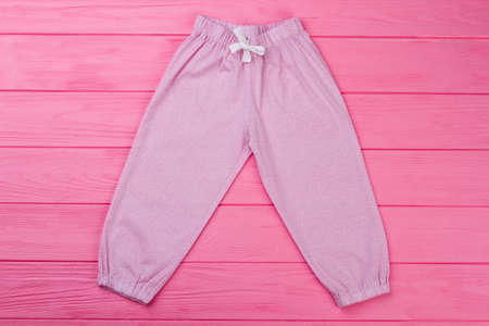 Pink pants with fine pattern. Pajamas bottom with elastic cuffs and waist. Cute garments for toddler girls.の写真素材
