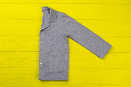 Boys shirt with pockets on yellow background. Gray melange cotton. Sleepwear for comfy night rest and lounge.の写真素材