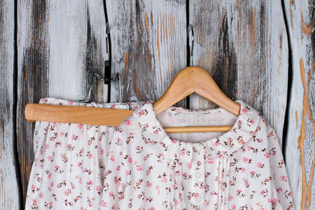 Floral pajama set on wooden hangers. Amazing hand-crafted nighties for teenage girls. Sweet and romantic design.の写真素材