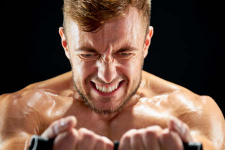 Sportsman making maximum efforts while training. Facial expressions show how painful and hard moves...