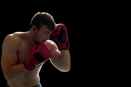 Young boxing fighter on black. Developing agility and accuracy, blow workout. Lifestyle and combat sports.の写真素材