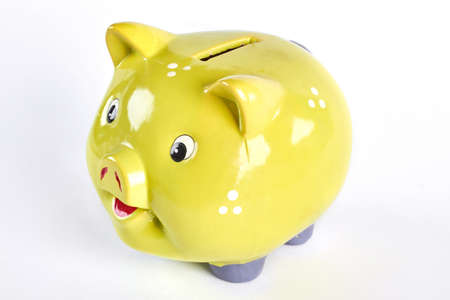 Cute yellow paggy bank for personal savings. Money box isolated on white background.の写真素材