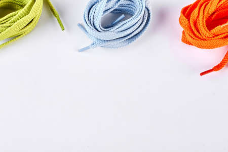 Multicolored shoe laces and copy space. Set of different colors shoes ropes isolated on white...