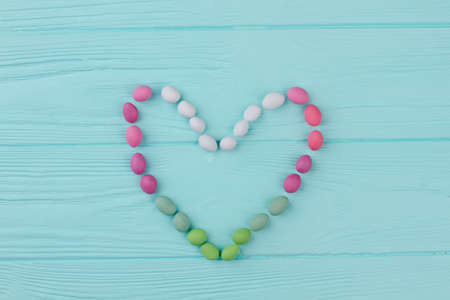 Love heart background, top view. Colorful candies on wooden background. Love and romance concept.の写真素材