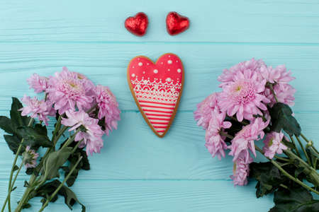 Heart shaped cookie and flowers. Love and romance design. Saint Valentines Day greeting card.の写真素材