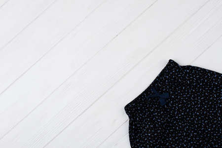 Girls pants on white wooden background. Cropped shot of clothes. Floral pattern. Discount sale, clothing collection.の写真素材
