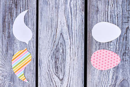 Paper cutouts for Easter holidays. Papercut eggs and birds on vintage wooden background, copy space. Handicrafting for Easter holidays, space for text.の写真素材