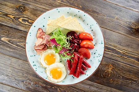 Fried juicy breakfast on plate. Various food in white plate. Beautiful looking food on plate.