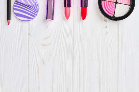 Make up set and space on top. Decorative cosmetics for make up on white wooden background, copy space.の写真素材