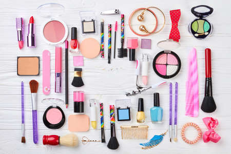 Makeup products kit, top view. Makeup cosmetics, brushes and other essentials on white background with copy space, top view. Beauty accessories flat lay.の写真素材
