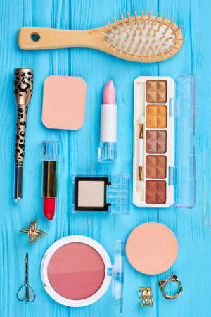 Cosmetics and jewelry wooden background. Creative flat lay of women cosmetics and accessories on wooden background. Fashion beauty for woman.の写真素材