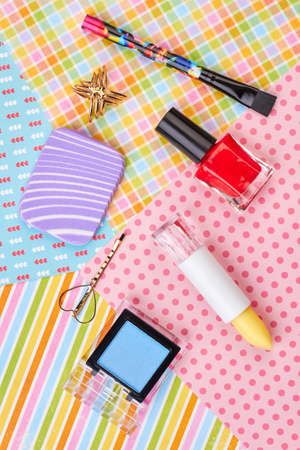Female makeup accessories, top view. Decorative cosmetics products and jewelry on colorful background. Woman beauty items.の写真素材