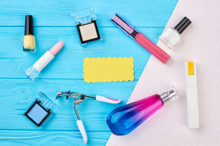 Yellow empty card and cosmetics set. Make up essentials, top view.の写真素材