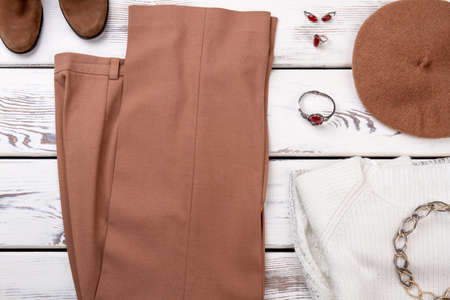 Flat lay classy apparel for women. Female elegant apparel and accessories on white wooden background. Woman fashion style essentials.の写真素材