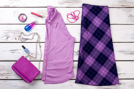 Flat lay female outfit and accessories. Set of women elegant apparel and beauty essentials, wooden background.の写真素材