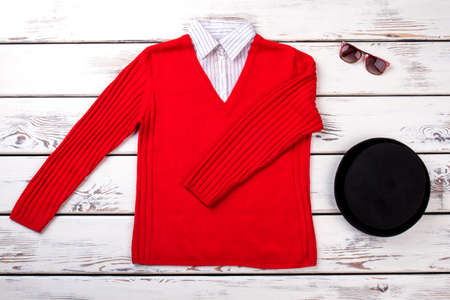 Female fashion sweater and accessories. Women knitted red sweater, black beret and sunglasses. Flat lay fremale clothes and accessories.の写真素材