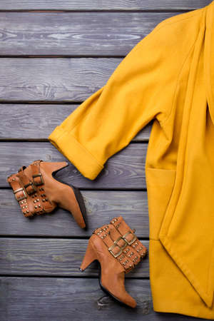Set of women elegant autumn clothes. Feminine soft cashmere topcoat and brown leather ankle boots,...