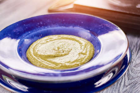 Spinach cream soup in porcelain plate. Delicious cream soup with spinach and celery. Tasty dish on plate.の写真素材