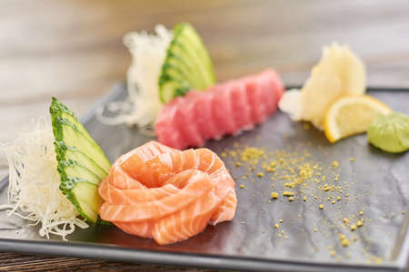 Raw salmon and tua sashimi. Sliced fresh tuna and salmon on japanese dish, focus on salmon.の写真素材