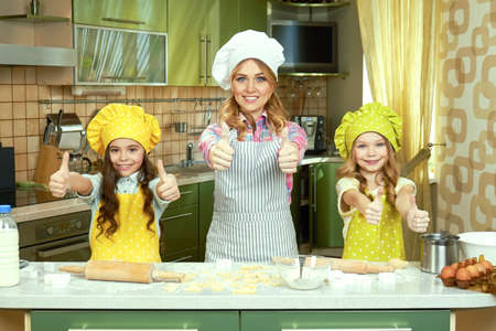 Happy female chef and children. People showing thumbs up.の写真素材