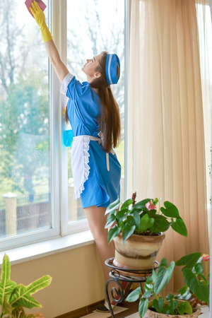 Housemaid cleaning window.の写真素材