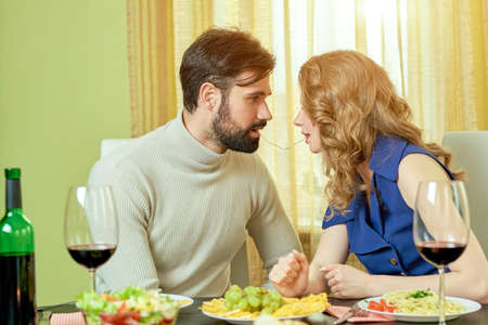 Couple sharing spaghetti. Romantic man and woman.の写真素材