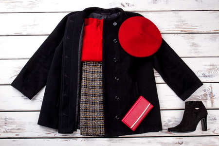 Full set of fashionable winter women clothes. Style and fashion concept. Bright beige white wooden desks surface background.の写真素材