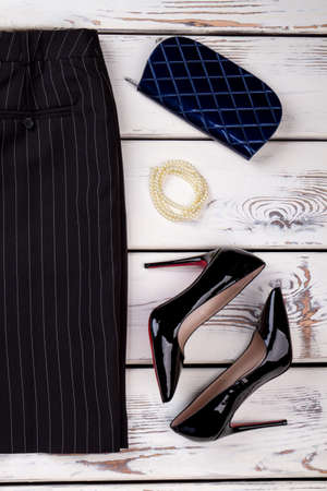 Casual and stylish clothing setup for women. Concept of black female clothes accessories, vertical view.の写真素材