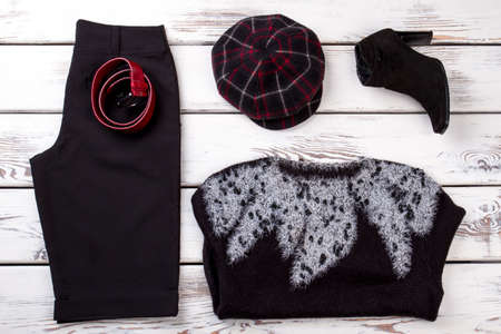 Set of women stylish fancy clothes, flat lay. White wooden desk background.