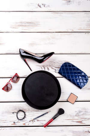 Overhead view of womens fashion set of accessories. Vertical view, flat lay, white wooden background.の写真素材