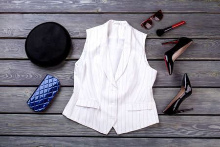 Fashionable fancy business clothing, flat lay. Black wooden surface background.の写真素材