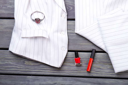 Rich expensive suit and accessories. Grey wooden surface background.