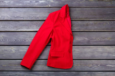 Folded red woman coat. Grey wooden surface background. Flat lay, top view.の写真素材