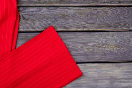 Close up red trouser-leg. Grey wooden surface background.の写真素材